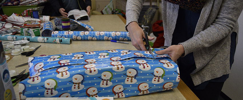 Volunteers wrap gifts